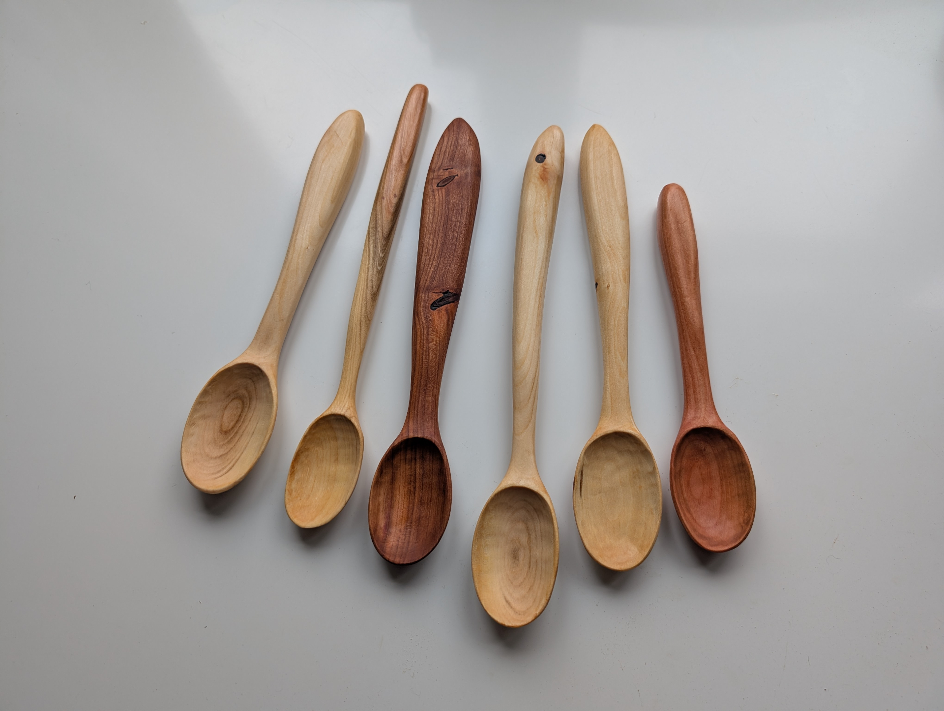 Six handcarved eating spoons in mixed reclaimed fruitwoods
